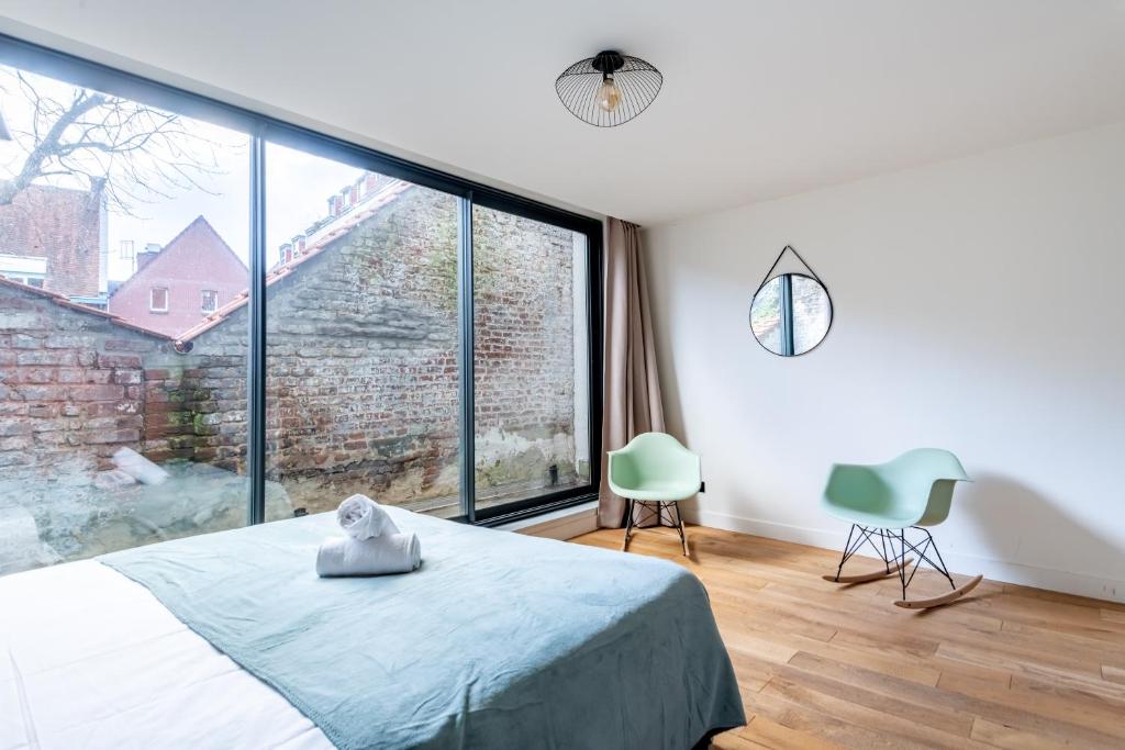 1 dormitorio con cama y ventana grande en NOCNOC - Le Ténor, Monnaie, en Lille