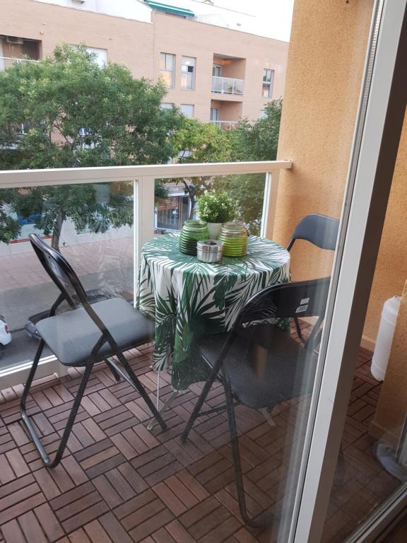 a table and two chairs on a balcony with a table and chairs at Lovely 2 bedroom apartment close to Denia Castle. in Denia