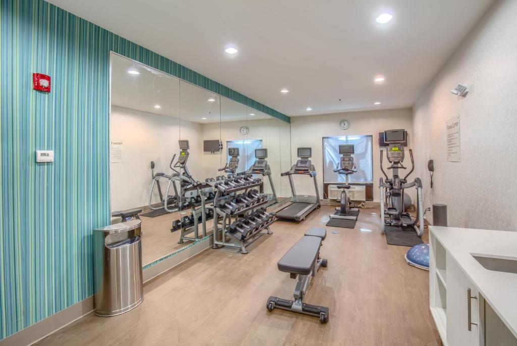 einen Fitnessraum mit mehreren Laufbändern und Kardiogeräten in der Unterkunft Holiday Inn Express Hotel &amp; Suites Gulf Shores by IHG in Gulf Shores