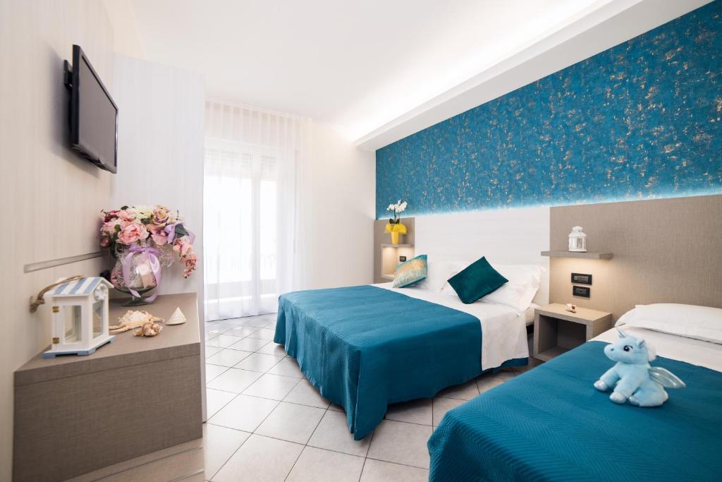 Postel nebo postele na pokoji v ubytování Viva Beach Hotel