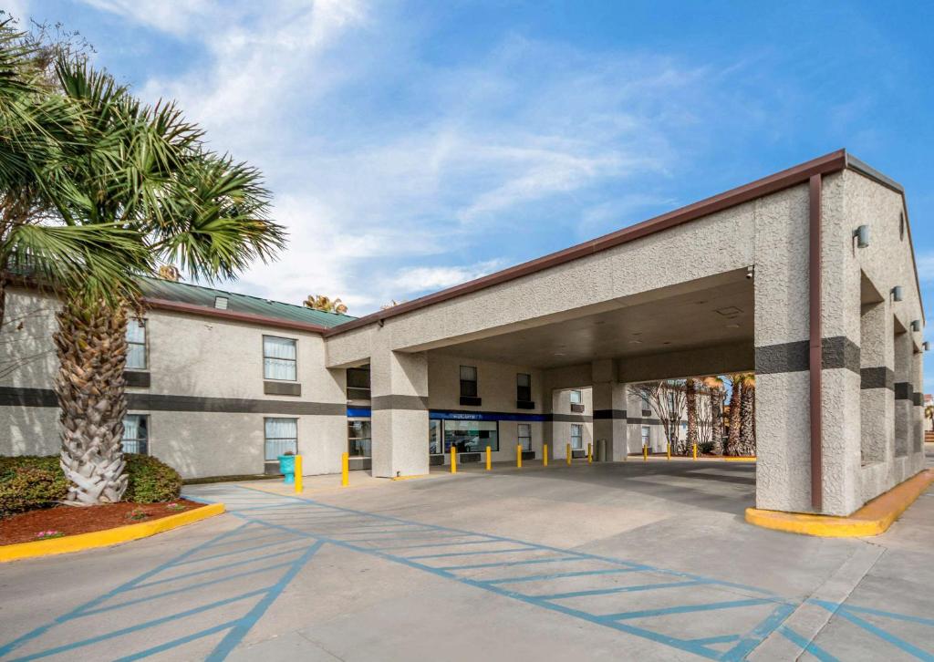 a building with a palm tree in front of it at Studio 6 Laredo, Tx - North I-35 in Laredo