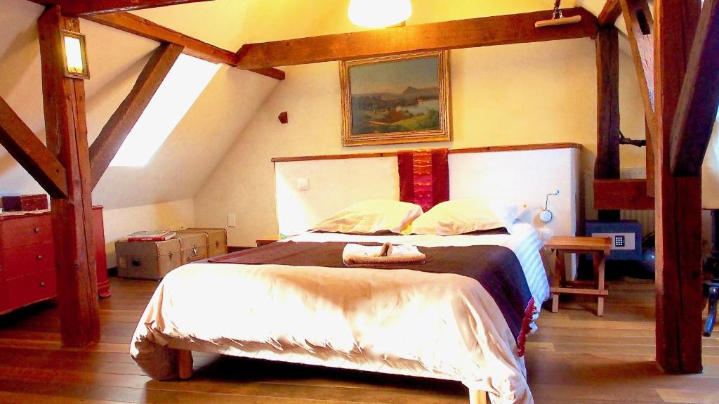 a bedroom with a large bed in a attic at La Maison de Caroline in Westhoffen