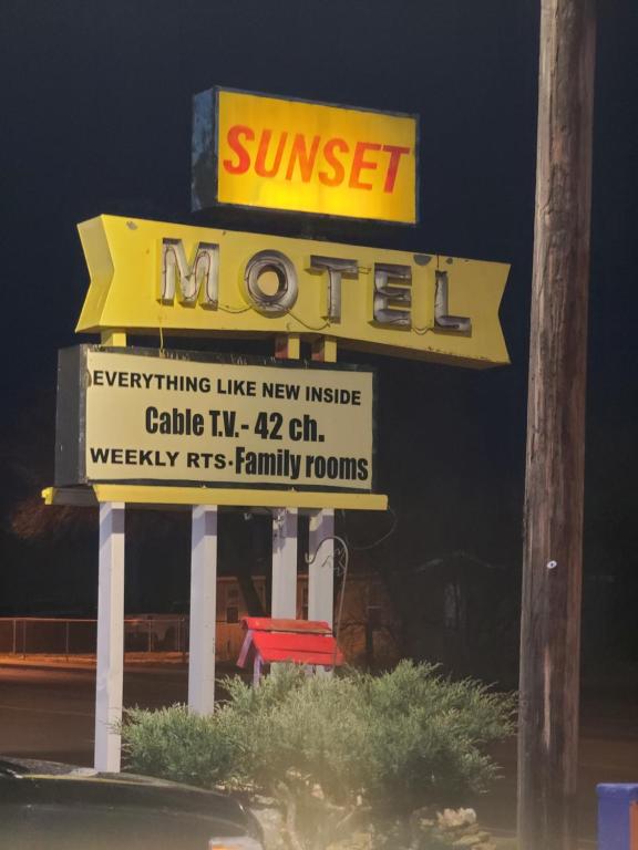 a sign for a motel with a sign for at Sunset Motel Santa Rosa, NM in Santa Rosa