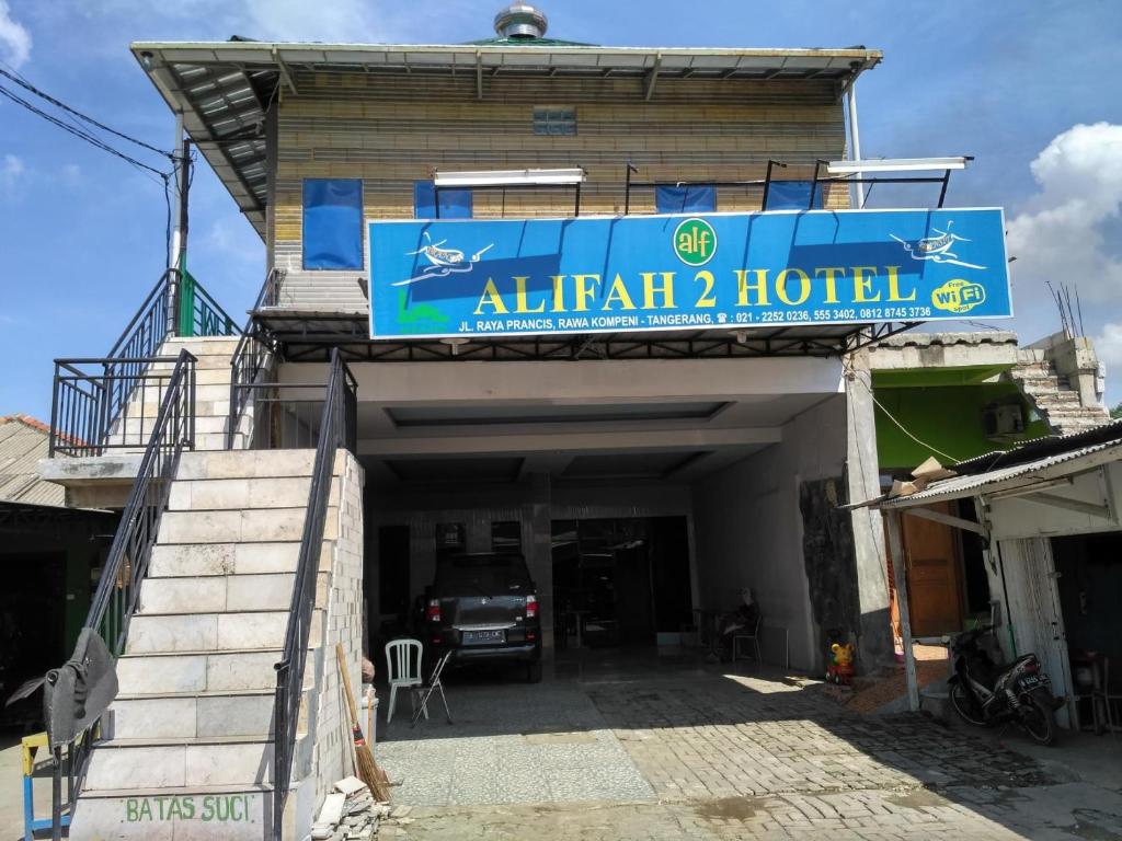 a building with a sign for an atlantis hotel at Hotel Alifah 2 in Tangerang