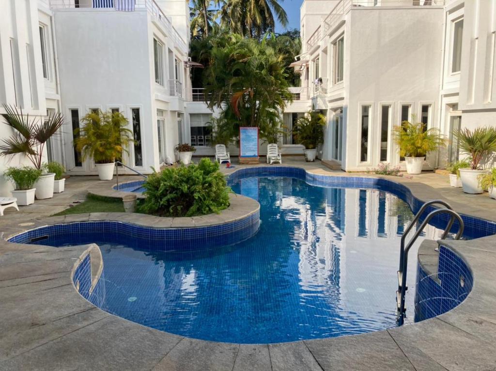 a swimming pool in the middle of a building at VILLA M - JIA 5 CANDOLIM GOA 3BHK, Pool Facing, Near Beach, Free Breakfast, Free WIFI and Prime Location in Candolim