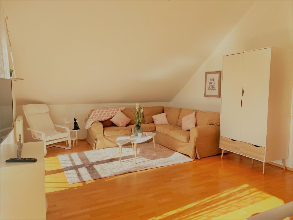 a living room with a couch and a table at Ferienwohnung Sonnenblick in Losheim am See in Losheim
