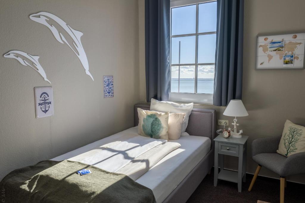 Postel nebo postele na pokoji v ubytování AKZENT Strandhotels Seestern, Delphin & Lachs