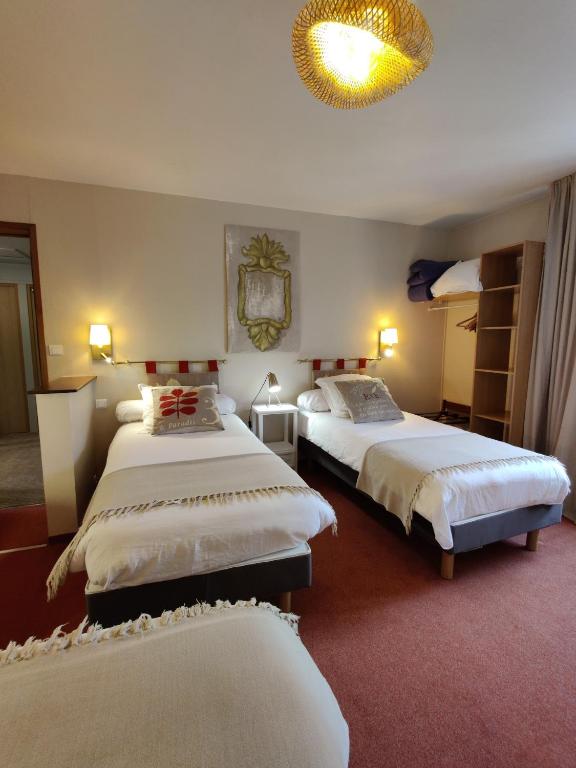 Postel nebo postele na pokoji v ubytování Hôtel Moderna