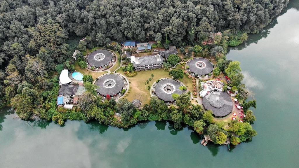 an aerial view of a house on an island in the water at Fish Tail Lodge in Pokhara