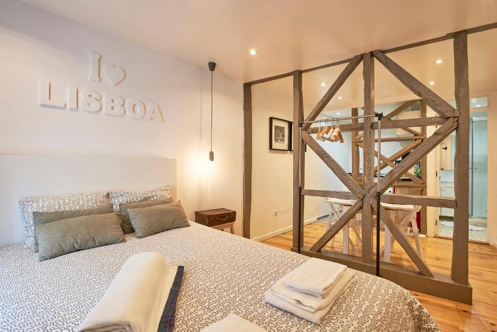 リスボンにあるApartamento Mira Graçaのベッドルーム1室(大型ベッド1台、木製のはしご付)