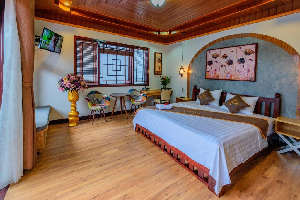 Postel nebo postele na pokoji v ubytování Art Villa Hoi An