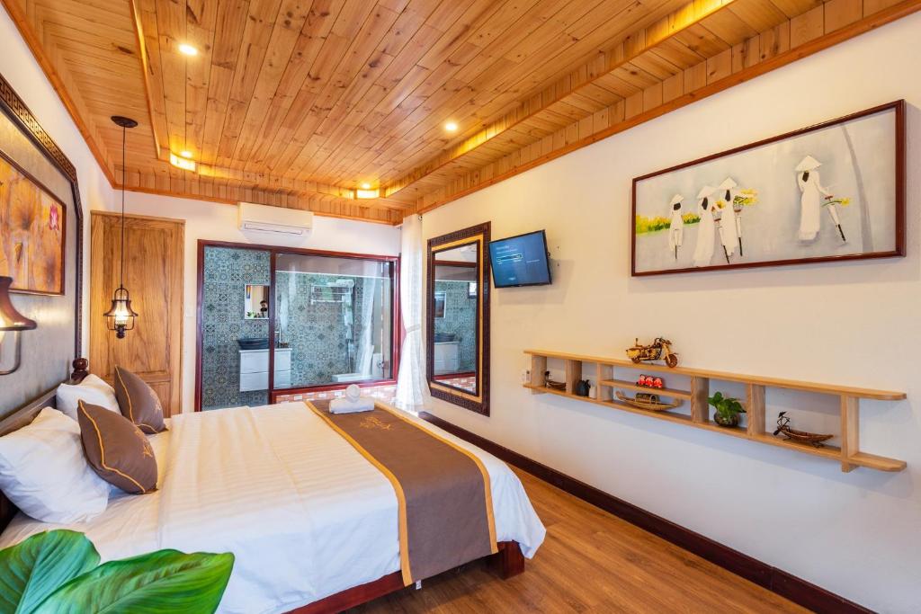 Postel nebo postele na pokoji v ubytování Art Villa Hoi An