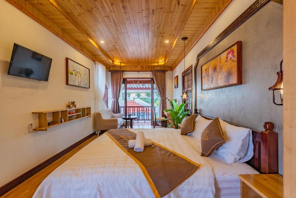 Postel nebo postele na pokoji v ubytování Art Villa Hoi An