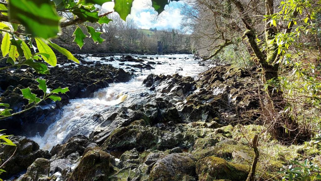 a river with rapids on the rocks at Finn Loft in Ballybofey