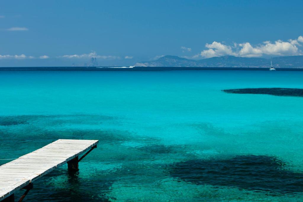 a dock in the middle of a large body of water at Mirador de Dalt Vila-Relais & Chateaux in Ibiza Town