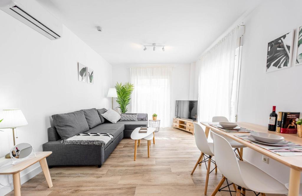 a living room with a couch and a table at Apartamentos Toboso Plaza in Nerja