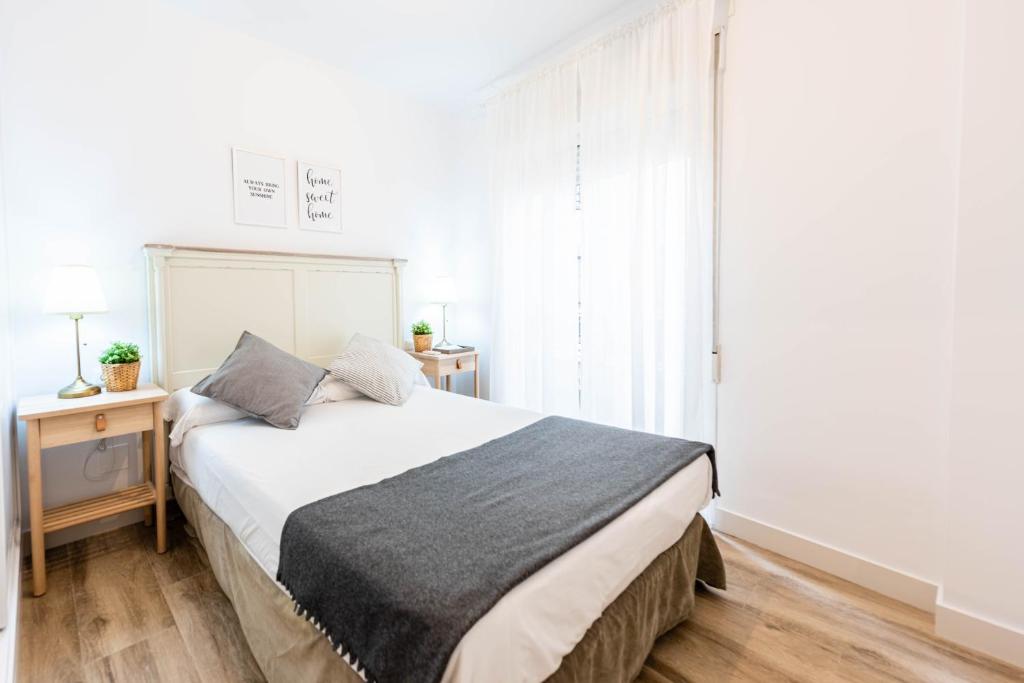 Posteľ alebo postele v izbe v ubytovaní Apartamentos Toboso Plaza