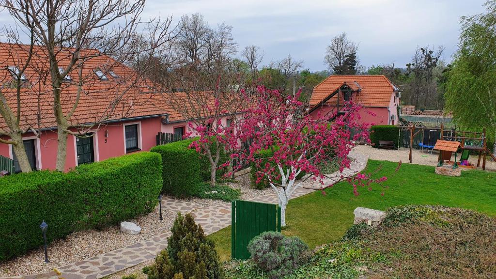 a house with a garden with pink flowers at Penzion Na Lednické in Hlohovec