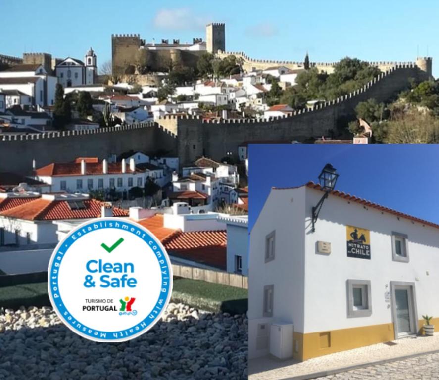 una señal de limpieza y seguridad frente a una ciudad en adubai Obidos, en Óbidos