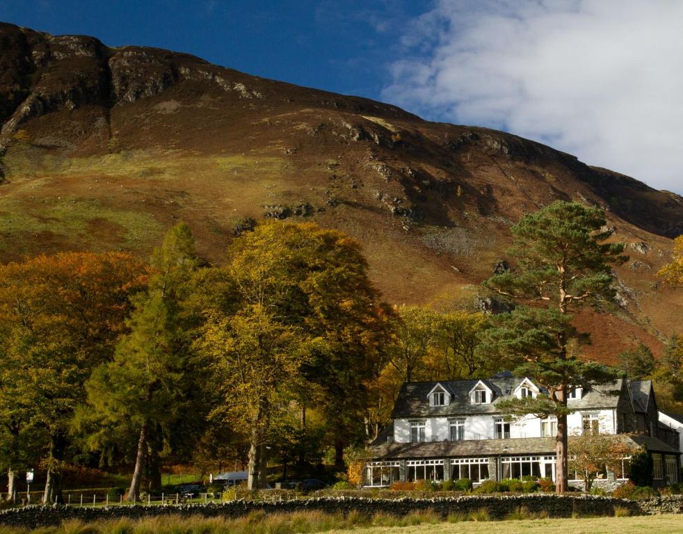 uma casa grande em frente a uma montanha em Borrowdale Gates Hotel em Keswick