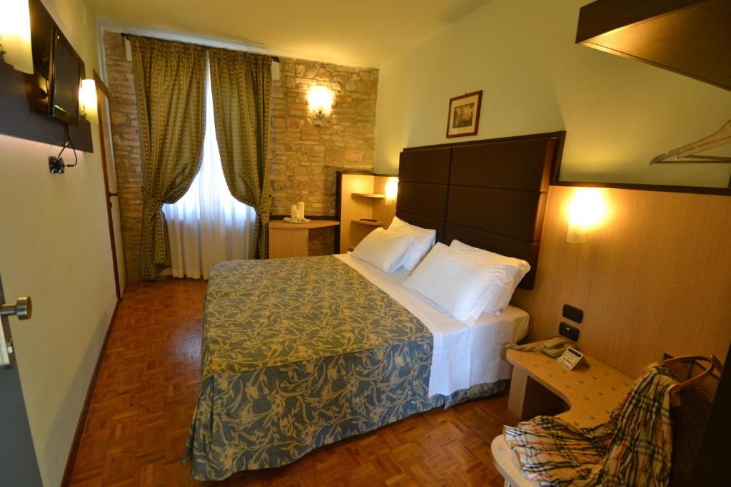 um quarto de hotel com uma cama num quarto em Hotel Il Castello em Assis