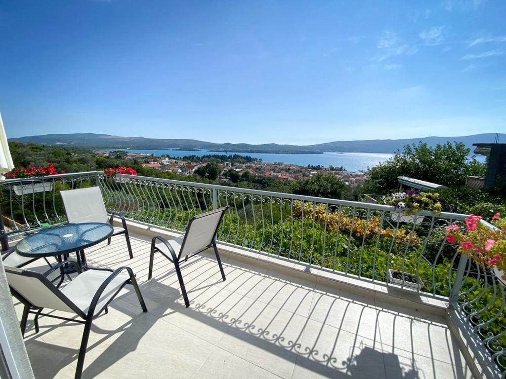 a balcony with chairs and a table and a view at Apartment Lana in Tivat