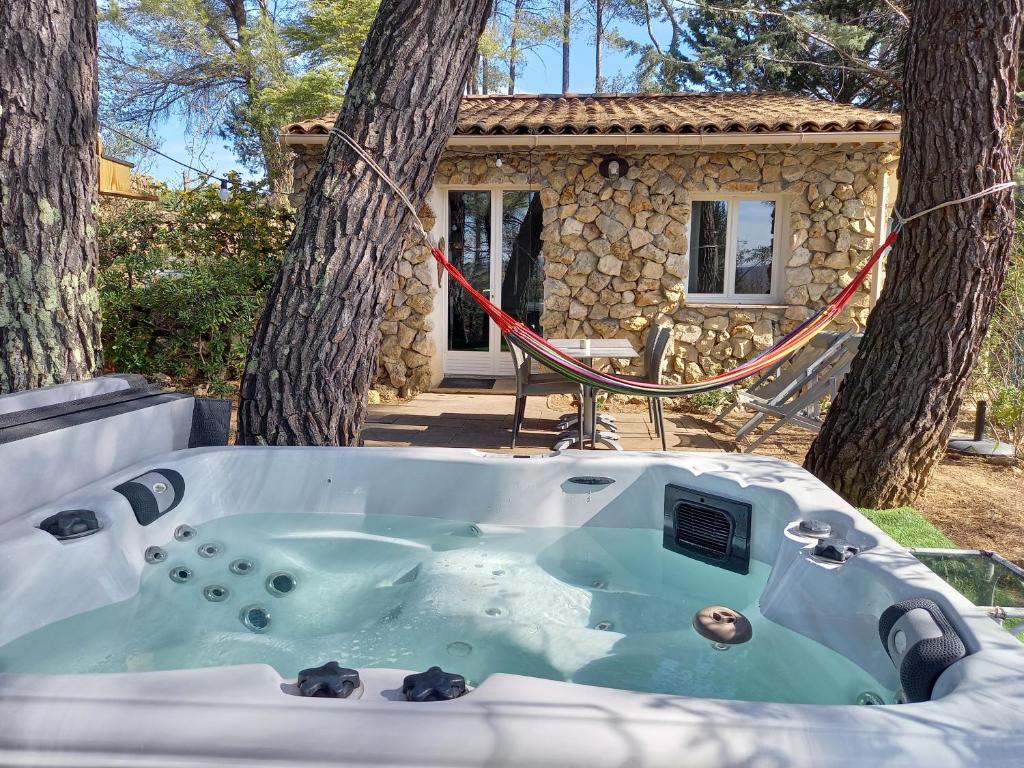 a jacuzzi tub in front of a house at GITE AVEC SPA JACUZZI au cœur de Provence Côte d'Azur in Saint Antonin du Var