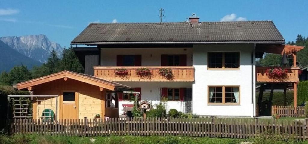 a white house with a fence in front of it at Fewo Aschauer in Schönau am Königssee