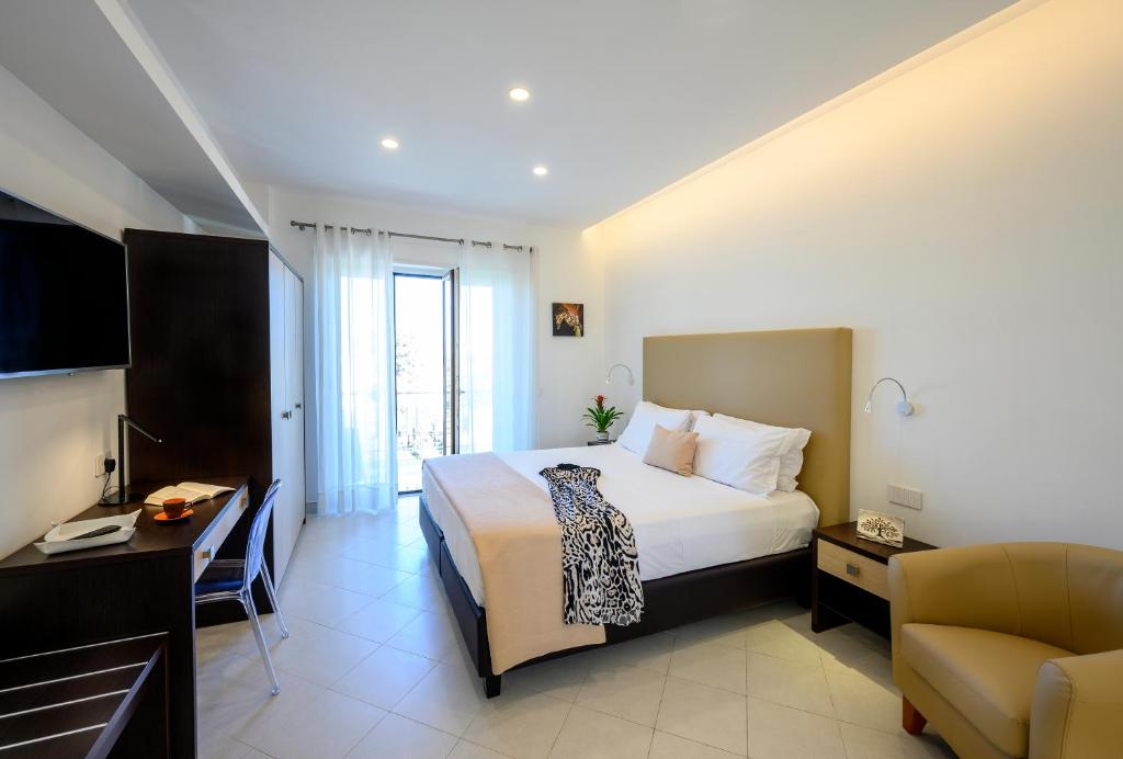 Habitación de hotel con cama y escritorio en Angiolina Apartments, en Sorrento