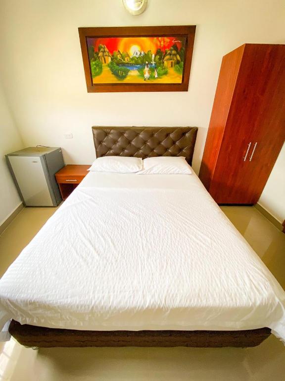 Postel nebo postele na pokoji v ubytování Hotel Aeromar Central