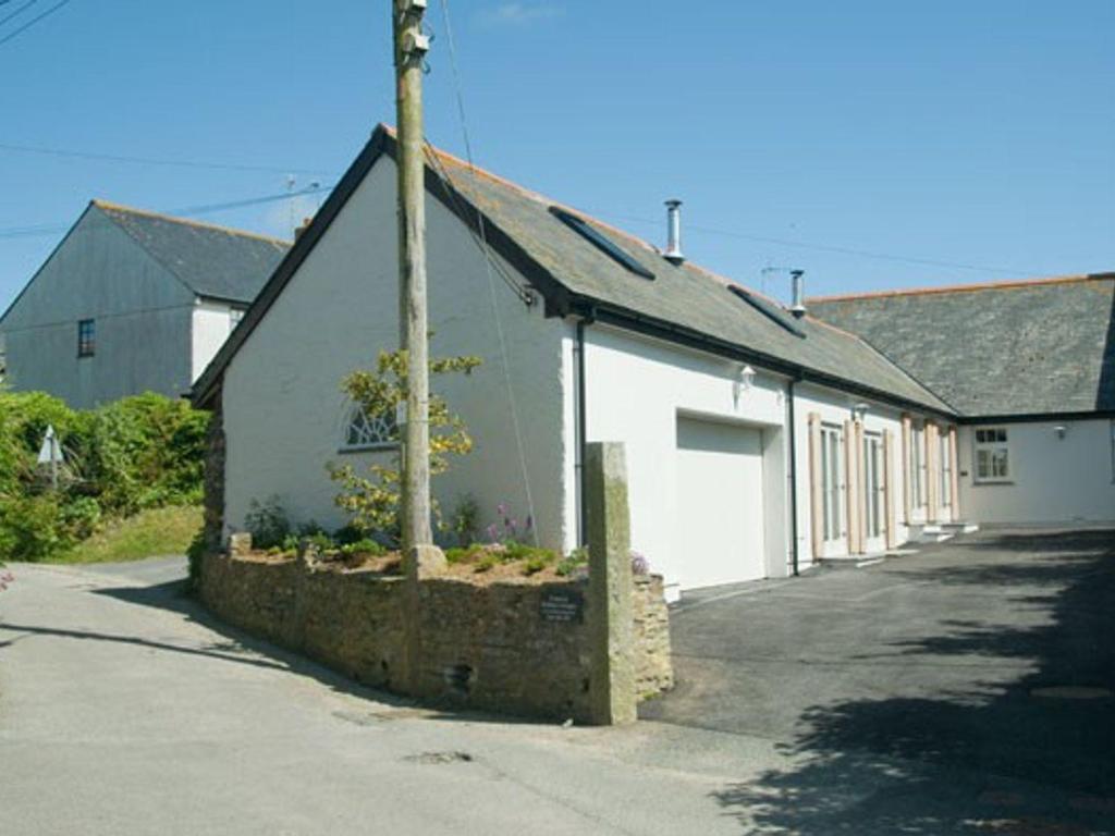 a white building with a pole in front of it at No 1 The Hinges in Newquay