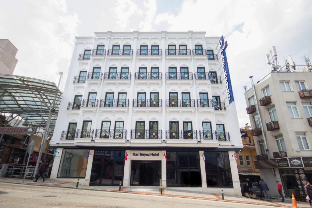 a white building on the corner of a street at KAR BEYAZ HOTEL BURSA in Bursa