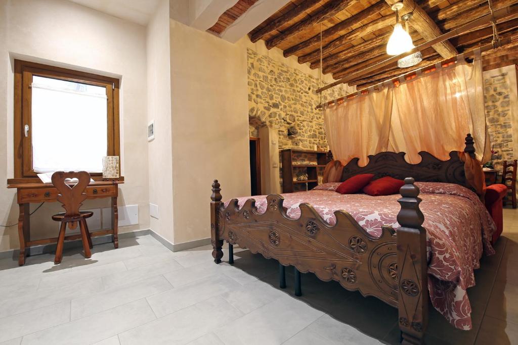 a bedroom with a wooden bed and a desk at Mella Bellagio -La Corte - at the Lake with parking in Bellagio