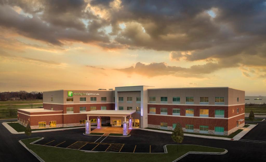 a hospital building with a sunset in the background at Holiday Inn Express & Suites - Lockport, an IHG Hotel in Lockport