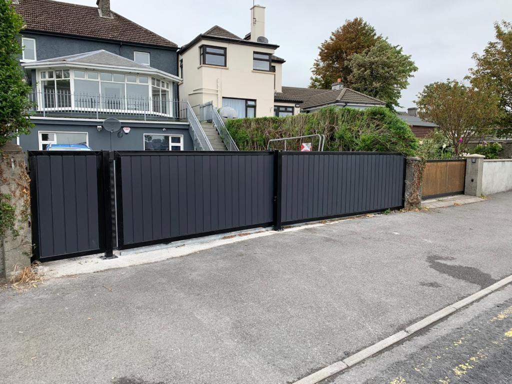 a black fence in front of a house at Bay View Holiday Home Galway in Galway
