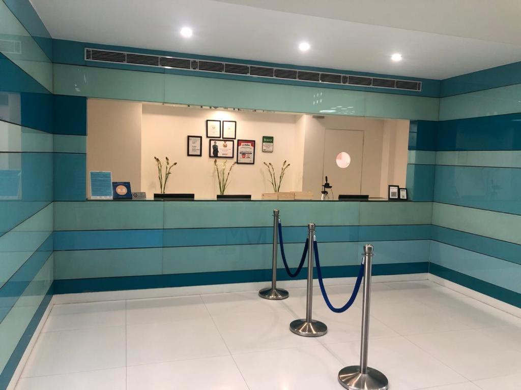 a waiting room with blue and white stripes at Cocoon Luxury Business Hotel in Dhanbād