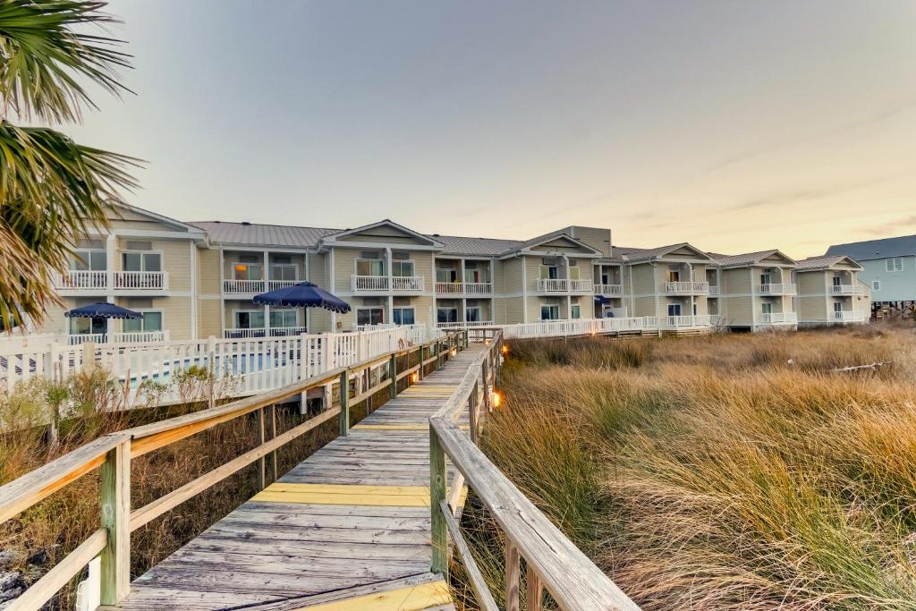 a boardwalk leading to the beach houses at Palm Suites in Atlantic Beach
