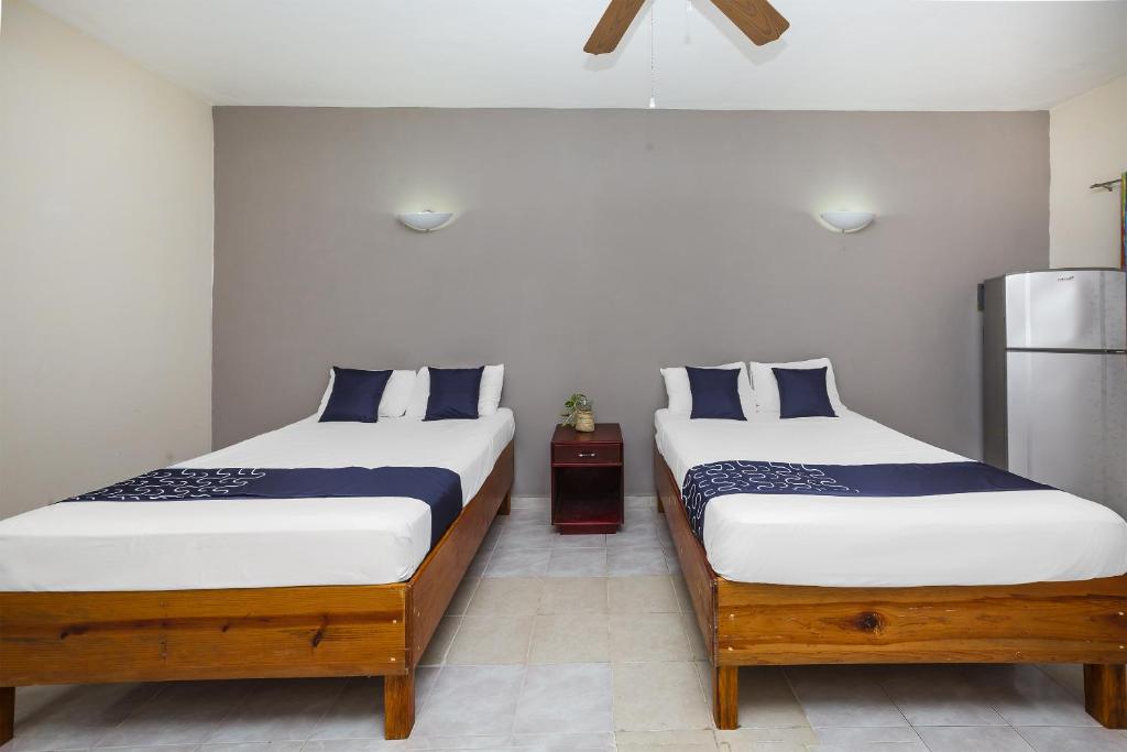 Postel nebo postele na pokoji v ubytování Hotel Kiin Cozumel