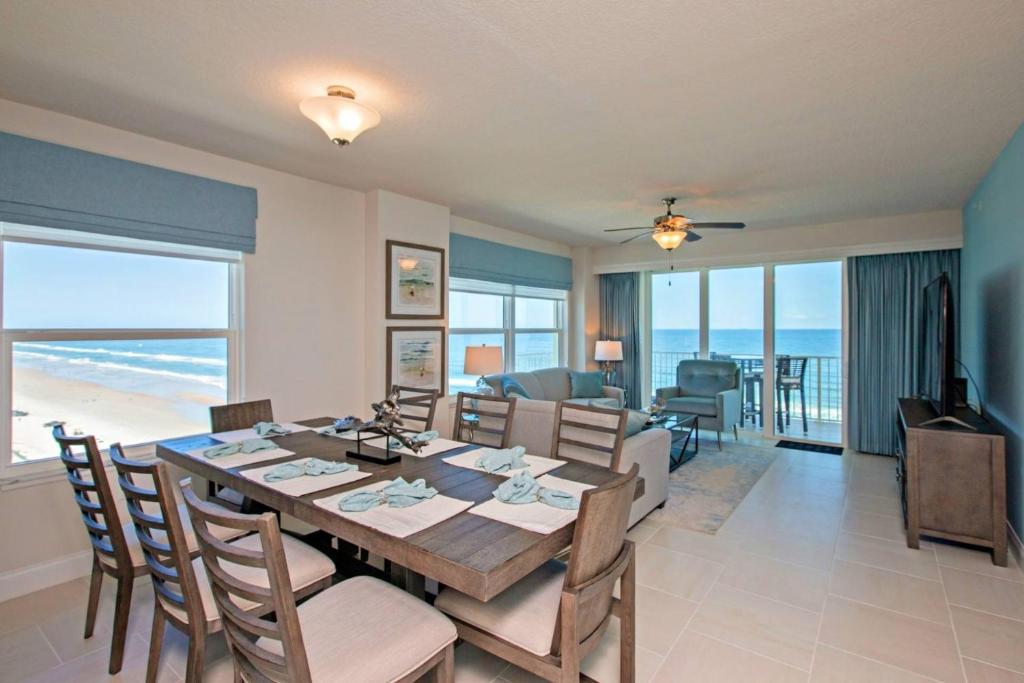 a dining room and living room with a table and chairs at Aruba Condo Unit #1102 in Daytona Beach Shores