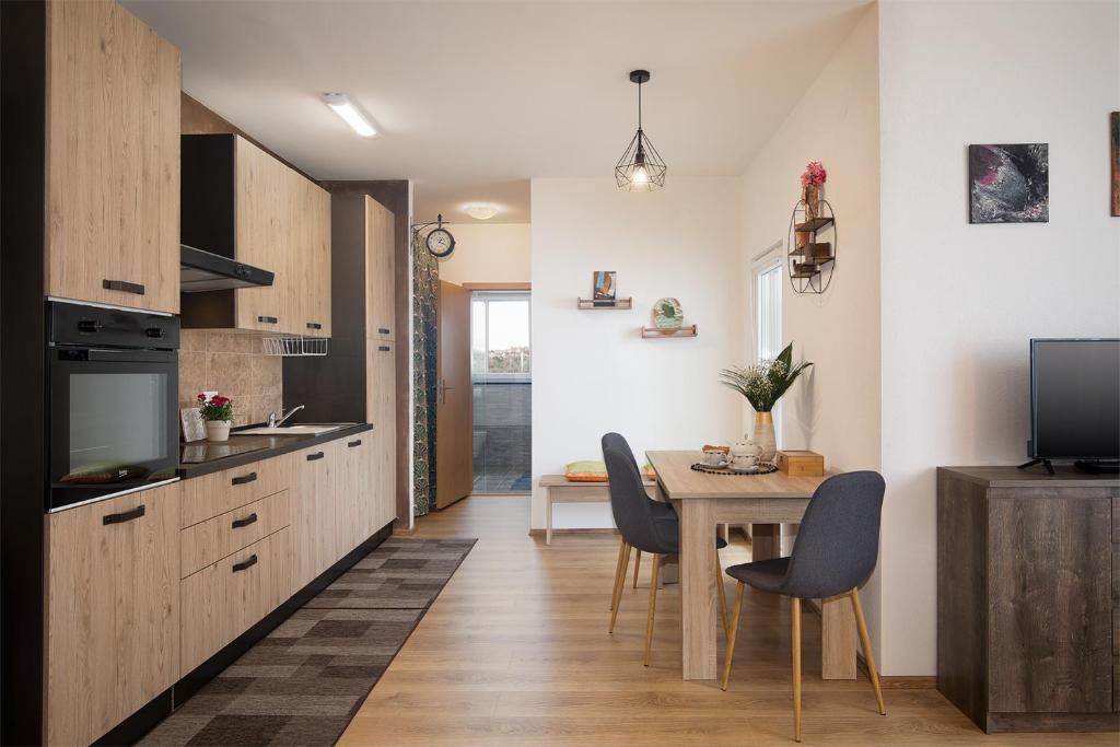 a kitchen and dining room with a table and chairs at Apartment Little Gallery **** in Rovinj