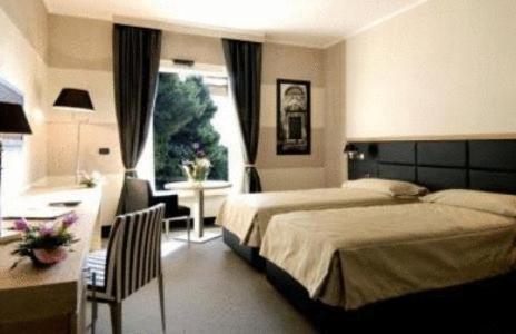 Łóżko lub łóżka w pokoju w obiekcie Hotel Pineta Wellness & Spa