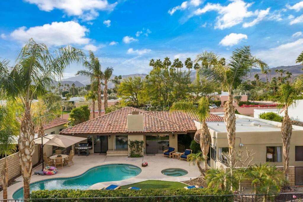 an aerial view of a house with a pool and palm trees at Everything You Want! Golf Course, Views, Pool/Spa in Palm Desert