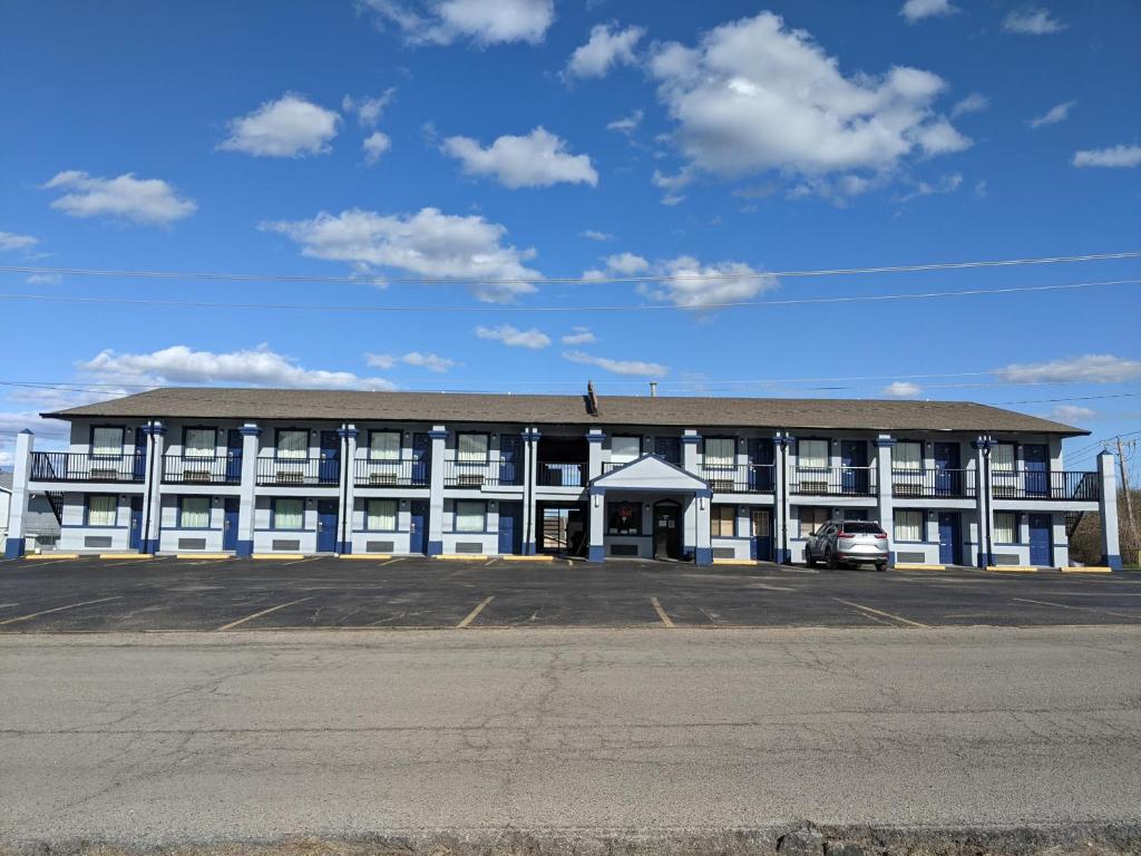 a large building with a parking lot in front of it at Eufaula Inn in Eufaula