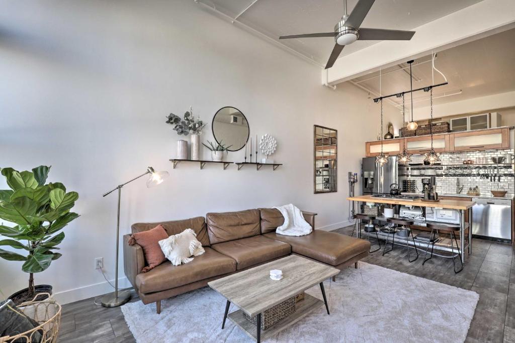 a living room with a couch and a table at Chic SLC Downtown Studio Loft Walk to Shops in Salt Lake City