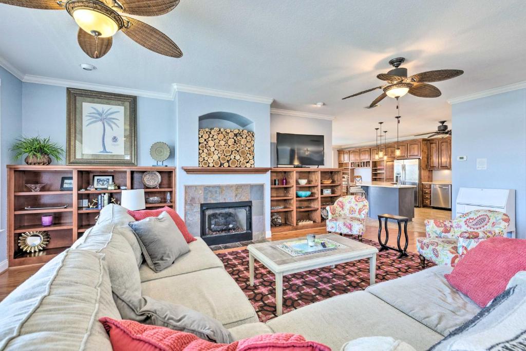 a living room with a couch and a fireplace at Spacious Gulf Shores Hideaway with Pool and Deck! in Gulf Shores