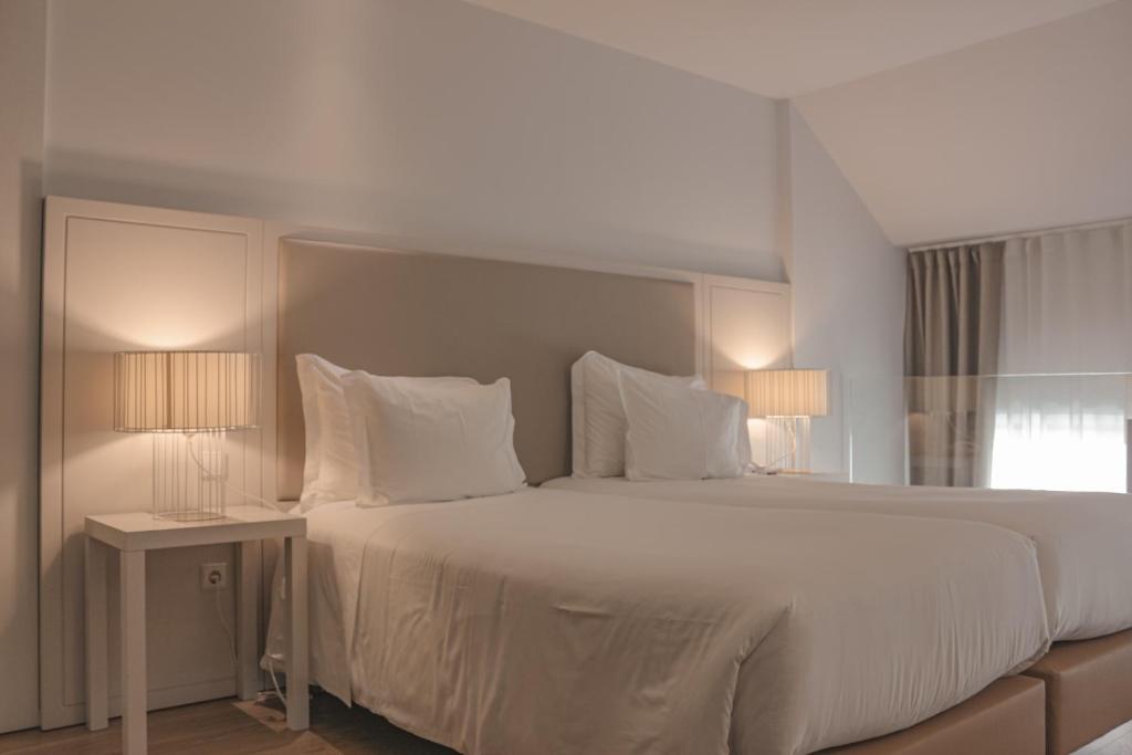 Postel nebo postele na pokoji v ubytování Burgus Tribute & Design Hotel