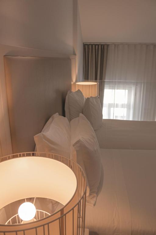 Postel nebo postele na pokoji v ubytování Burgus Tribute & Design Hotel