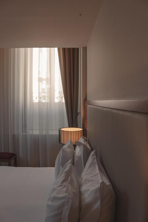 Postel nebo postele na pokoji v ubytování Burgus Tribute & Design Hotel
