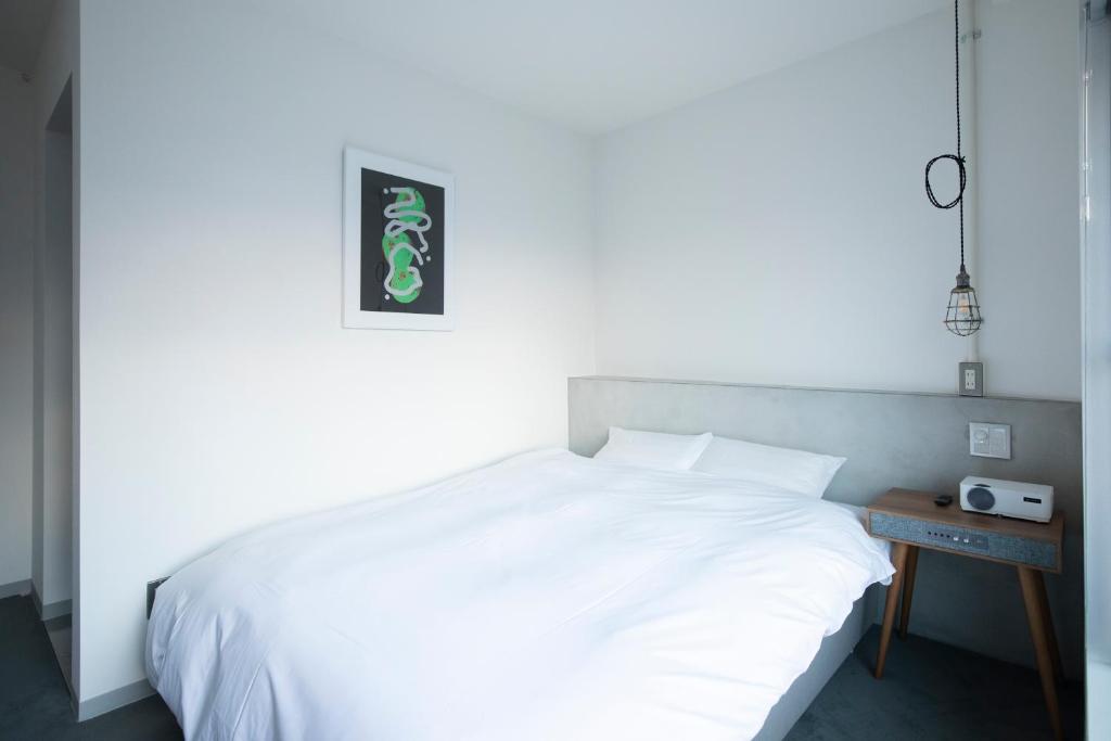 Postel nebo postele na pokoji v ubytování BENJAMIN HOTEL KANAZAWA