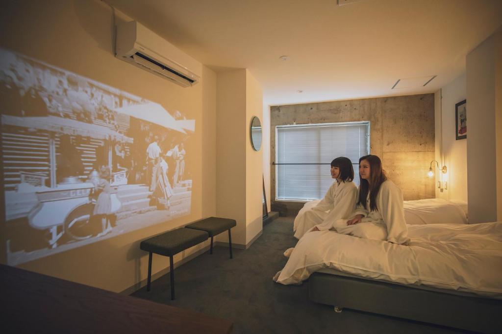 Postel nebo postele na pokoji v ubytování BENJAMIN HOTEL KANAZAWA